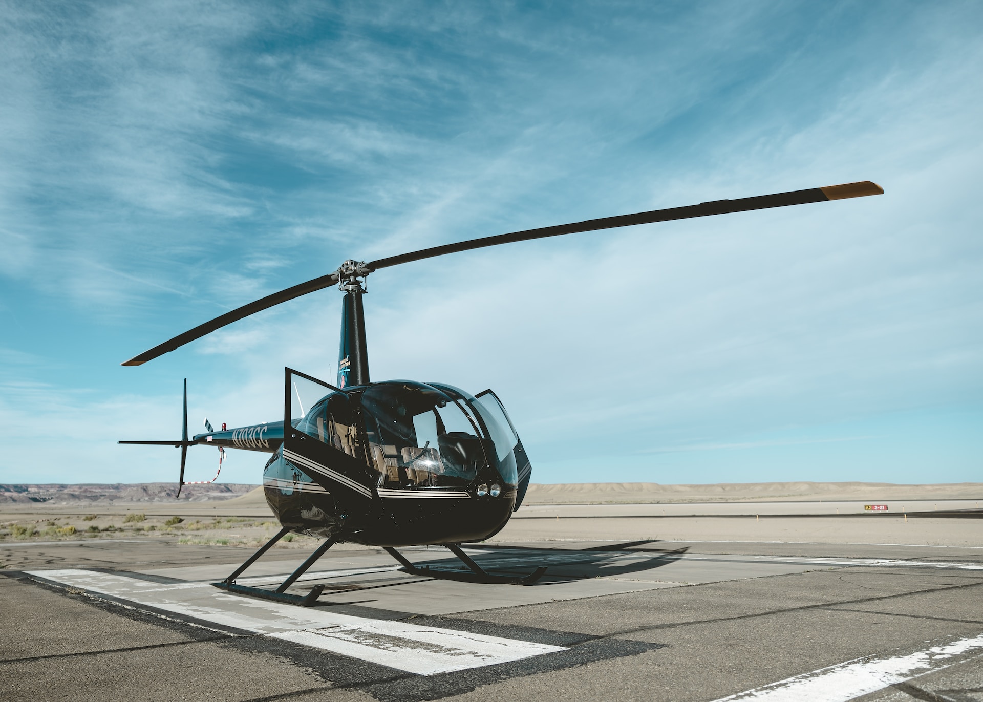Robinson R44 helicopter on a helipad