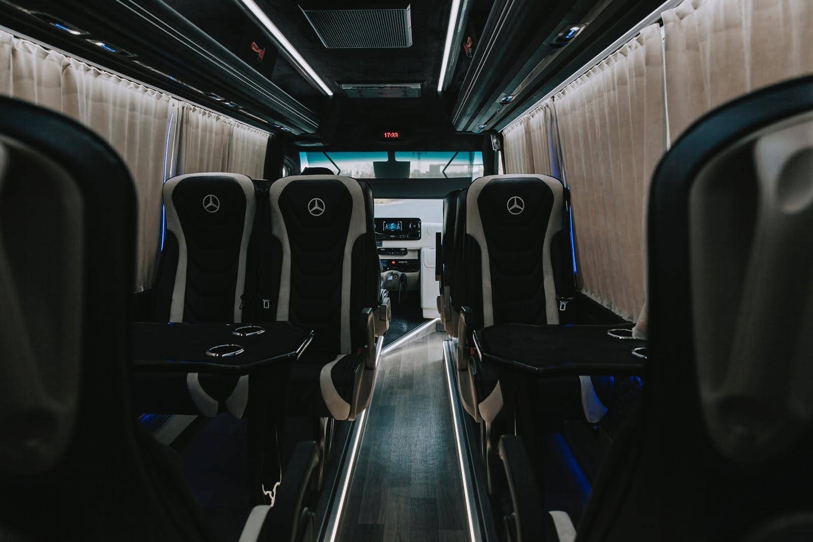 Inside a VIP Sprinter minibus: captain seats and tables
